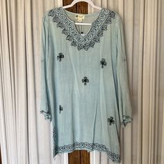 Pretty Light Blue Tunic Top/Cover-Up. Dark Embroidered Accents. Notched Side Hems. Machine Wash. Pet And Smoke Free Home. Armpit To Armpit: 23” Length: 33” H43611 Spring Beach Embroidered Blue Top, Spring Blue Embroidered Top For Beach, Blue Embroidered Top For Spring Beach Occasion, Casual Blue Embroidered V-neck Top, Blue V-neck Embroidered Top For Beach, Light Blue Embroidered V-neck Top, Casual Embroidered Spring Tunic, Casual Spring Tunic With Embroidery, Casual Embroidered Tunic For Spring