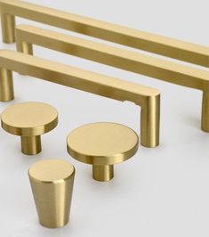 an assortment of brass colored furniture on a white background