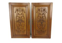 two wooden doors with intricate carvings on the front and back sides, one is open