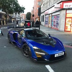 a blue sports car is parked on the street