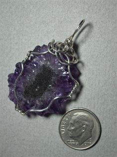 Amethyst Crystal Sun Pendant Wire Wrapped in .925 Sterling Silver Round Wire Also called solar amethyst; brilliant light to medium purple amethyst crystal points radiating out from a charcoal black oval center define this stone; it especially compliments pink, purple, red, burgundy, and blue colors of clothing, wears well with light to medium color combinations for contrast, and an enlivening, refreshing choice when worn with darker colors. An irregular radial crystal pattern, color variations, Crystal Pattern, Sun Pendant, Semi Precious Gems, Stone Wrapping, Medium Purple, Red Burgundy, Charcoal Black, Precious Gems, Hand Made Jewelry