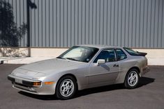 a silver sports car parked in a parking lot