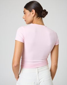 This jersey style t-shirt features supersoft material, short sleeves and a long line length. Athleisure Stretch T-shirt For Spring, Sporty Pink Jersey Top, Minimal Stretch Spring Tops In Athleisure Style, Trendy Solid Color Elastane T-shirt, Spring Sporty Tops With Shirttail Hem, Basic Stretch Tops With Shirttail Hem, Sporty Spring Tops With Shirttail Hem, Trendy Pink Stretch Short Sleeve Top, Pink Short Sleeve Top In Elastane