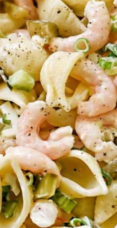 pasta salad with shrimp and scallops in a white bowl