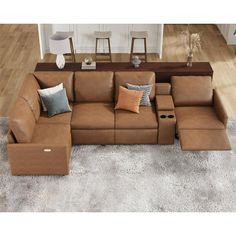 a brown sectional sofa sitting on top of a white rug