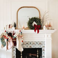 stockings hanging from a fireplace mantel decorated for christmas