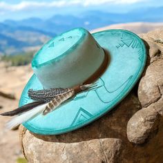 Embrace the essence of the Wild West with this striking teal hand burned hat featuring a unique fusion of southwestern designs and rugged charm. Crafted with meticulous attention to detail, the hat boasts an intricate bull skull motif amidst traditional southwestern accents that radiate authenticity. Its wide brim exudes classic Western fashion while providing ample shade, making it a versatile accessory for both style and function. This cordobez hat is not just a fashion statement but a nod to the sun hats worn by true pioneers. Elevate your look with this eye-catching piece that captures the spirit of the frontier with a contemporary twist. If you'd like completely custom design on a hat please reach out and send me a message, ill be happy to design one for you!! *This hat is hand burned Artisan Turquoise Hats For Western-themed Events, Artisan Turquoise Hat For Western-themed Events, Green Bohemian Hat, Turquoise Hats For Kentucky Derby And Festivals, Turquoise Hat For Kentucky Derby Festival, Turquoise Bohemian Hat For Kentucky Derby, Turquoise Hat For Festival And Kentucky Derby, Artisan Turquoise Hat With Curved Brim, Artisan Turquoise Curved Brim Hat