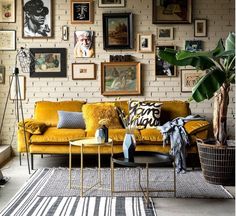 a living room filled with lots of pictures on the wall and a couch in front of it