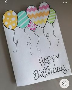 a birthday card with balloons and the words happy birthday written in black ink on white paper