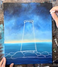 someone is drawing something in the air with chalk pastels on a piece of paper