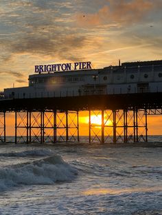 the sun is setting at brighton pier