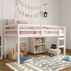 a white bunk bed sitting on top of a wooden floor next to a book shelf