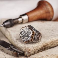 This handcrafted men's silver ring bears the profound Hadith 'المرء مع من أحب' (One is with whom he loves) on a silver plaque, a reminder of love's bond in Islamic tradition. The ring's hexagonal form is adorned with an intricate Abjad numerals motif, symbolizing the mystique of Arabic numerals. This piece is a fusion of spiritual meaning and artistic craftsmanship, making it a unique addition to any collection or a heartfelt gift. * Discover our handmade Agate stone minimal ring in silver natur Artisan Handmade Signet Ring As Gift, Handmade Artisan Signet Ring For Gift, Artisan Hallmarked Signet Ring As Gift, Artisan Engraved Hallmarked Ring As Gift, Artisan Engraved Hallmarked Ring For Gift, Artisan Ring With Stamped Detail As Gift, Artisan Stamped Rings As Gifts, Artisan Engraved Ring For Gift, Artisan Engraved Ring With Polished Finish For Gift