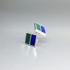 "Malachite and Lapis Lazuli square green and blue stud earrings with silver. Unique gift for her or him, friend, girlfriend, wife, September and October birthstone, 9 year anniversary. Modern and minimal square earrings combining blue Lapis with green Malachite. This beautiful earrings are worked with the technique of inlay, which means the stone is worked seamlessly into the Sterling silver. Each earring is divided into to rectangle parts divided by a 1mm silver line.  Our silver is Sterling silver and nickel free. All our stones are natural stones and our jewelry is handmade, slight differences in color and size may occur. Our inlay work is made with real stone and NOT stone dust. Please note the size specifications!  Earring size: 11 x 11 x 2 mm stone size per rectangle: 11 x 5 mm weigh Rectangular Polished Earrings For Gifts, Rectangular Polished Earrings For Gift, Rectangular Polished Finish Earrings For Gift, Sterling Silver Rectangular Gemstone Earrings, Modern Green Earrings As Gift, Rectangular Sterling Silver Jewelry With Inlay, Unique Rectangular Inlay Jewelry, Green Modern Sterling Silver Earrings, Modern Green Sterling Silver Earrings