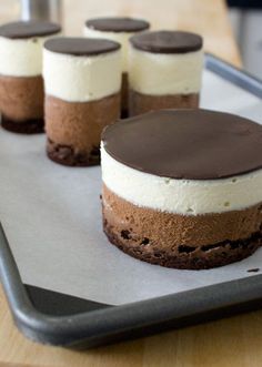 there are four desserts on the tray ready to be eaten