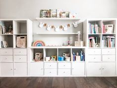 a white bookcase filled with lots of books