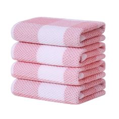 four pink towels stacked on top of each other