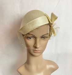 Gorgeous mini hat / cap with structured bow. Hat is creamy white with textured lines giving a touch of a hold tone. Marked size 22 Shown on mannequin head 23" The netting needs to be replaced. Perfect hat for a elegant wedding or formal affair. Bridal Cap, Mini Hat, Wedding Fascinators, Mannequin Head, Albany Ny, Mannequin Heads, Vintage Hats, White Caps, Creamy White