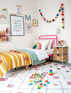 a child's bedroom decorated in pink, yellow and green