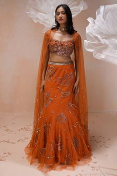 Burnt orange net mermaid lehenga with an attached cancan and floral motifs, sequins and zari hand embroidery. Comes with a padded blouse and dupatta. - Aza Fashions Orange Anarkali Style Organza Sharara, Fitted Orange Gown For Festive Occasions, Orange Anarkali Organza Sets, Orange Sharara With Pallu For Reception, Orange Sharara With Resham Embroidery For Reception, Orange Party Choli Unstitched Blouse, Orange Organza Lehenga For Wedding, Orange Lehenga With Unstitched Blouse For Reception, Orange Anarkali Lehenga In Organza