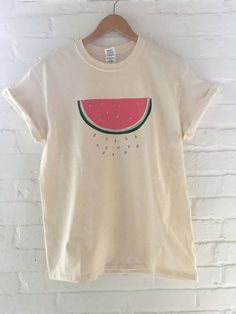 "Hand Printed and Hand Drawn! This is a 100% cotton screen printed t shirt with a hand drawn watermelon. It's perfect for summer! The shirt shown here is natural cotton and is printed in red and green ink. If you are interested in a different color shirt, just message us and ask! // PROCESS: All of our items are individually hand printed by either me or my dad, which can lead to slight variations in placement. The ink is heat cured and will not fade over time. Since our items are printed to orde Screen Print Shirt, Watermelon Shirt, Fruit Shirt, Food Shirt, Screen Printing Shirts, Fruit Print, Color Shirt, Mens T Shirts, Shirt Pattern