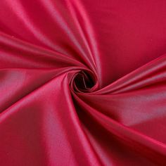 a close up view of a red satin fabric