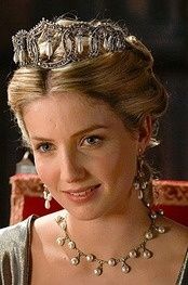 a woman wearing a tiara and pearls