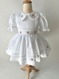 ✿ABOUT THIS DRESS ✓Our hand-embroidery dress is made from high-quality cotton fabric, this dress features a fluffy tutu-supported skirt lined with soft cotton for ultimate comfort. ✓The frilled collar and rib impositions on the front part of the dress and skirt add a touch of elegance, while the bow tie belt accentuates your child's waistline for a flattering fit.  ✓Every flower embroideries adorning the dress - each hand-crafted with exquisite attention to detail by our skilled artisans. ✿FABRI Under The Skirt, Girls White Dress, Hand Embroidery Dress, Embroidery Dress, Embroidery Details, Embroidered Flowers, Embroidery Flowers, Vintage Children, Baby Girl Clothes