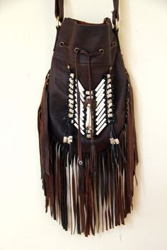 Medium fringed leather bag, antique brown color, boho style Handcrafted bone bead and natural coconut bead embellishment choker attached as decoration Fully lined inside with one pocket. The adjustable leather shoulder strap fits either across the body or slung over your shoulder. Material: leather, cow bones,coconut bead, turquoise crystal bead 8.2 in wide, 11.4 in long. total long include feather fringes 18.9 in aprox 21 cm wide,29 cm long. total long include leather fringes 48 cm aprox Best f Bohemian Brown Shoulder Bag, Bohemian Brown Shoulder Bag For Festival, Bohemian Festival Bags With Beaded Fringe, Bohemian Brown Bag With Beaded Fringe, Hippie Brown Handmade Shoulder Bag, Hippie Handmade Brown Shoulder Bag, Bohemian Leather Hobo Bag With Tassels, Bohemian Leather Bag With Tassels, Bohemian Brown Shoulder Bag With Fringe