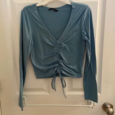 Never Worn Shein Blue Long Sleeve Top With Front Tie Scrunch V-neck Drawstring Top For Spring, Blue Ruched Tops For Spring, Casual Long Sleeve Ruched Tops, Casual Blue Top With Drawstring, Fitted Blue Top With Drawstring, Spring V-neck Top With Drawstring, Fitted Long Sleeve Top With Drawstring, Casual V-neck Top With Drawstring, Spring V-neck Drawstring Top