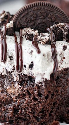 a close up of a piece of cake with ice cream and oreo cookies on top