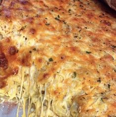 a large cheesy pizza with cheese on it