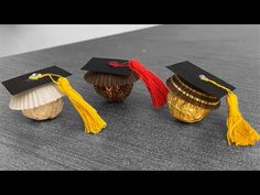 three graduation caps and tassels are placed on top of each other in the shape of shells