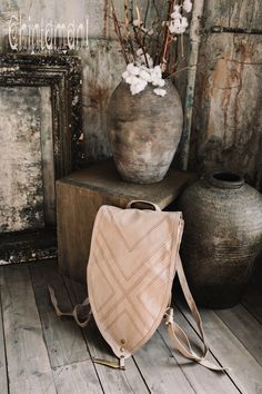 "⫸ We ship by EXPRESS EMS now for fast & safe delivery! Our unique shield shaped unisex boho backpack is a gorgeous artifact to carry your everyday necessities around. It is made out of double layered strong cotton canvas and decorated with huge solid brass feather pendant, as well, as geometric tribal protective stitching. The straps are regulated with beautiful brass rings and can be adjusted in length for your convenience. There are two secure small zipped pockets for valuables and gadget Bohemian Beige Backpack, Bohemian Backpack For Everyday Use, Bohemian Leather Backpack For Daily Use, Bohemian Satchel Backpack For Everyday Use, Bohemian Leather Backpack With Adjustable Strap, Bohemian Leather Backpack For Everyday, Bohemian Leather Backpack For Everyday Use, Everyday Bohemian Leather Backpack, Navajo Pattern