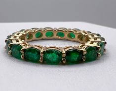 18K Gold Oval Emerald Eternity Band METAL: 18K yellow gold. Can be made in White or Rose Gold upon request GEMSTONES: EMERALDS: 17 Oval Shaped Emeralds MEASUREMENT: 3.2x4.2 mm (the measurements of each individual stone may vary slightly) CARAT WEIGHT: 2.58 ct.  **Information based on US Ladies Size 6.5 If you'd like this ring custom made with different gemstones, I can do that! Please message me for more information. SIZES: Ladies sizes 4-9. Prices vary based on size. If you'd like a bigger size Emerald Eternity Band, Band Metal, Green Rings, The Lucky One, Take A Shower, Eternity Band, Eternity Bands, Eternity Ring, Rings Statement