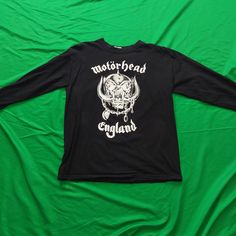 "Motorhead Classic \"Snaggle Tooth - Motorhead England\" Black Longsleeve T-Shirt.  A variation on the black t-shirt classic.  These were sold at the shows in 2000.  The back features the classic \"Everything Louder Than Everything Else\" Slogan.  This shirt is brand new and has never been worn." Punk Black T-shirt For Biker Events, Fan Merchandise Band Logo Long Sleeve Tops, Biker Skull Print Crew Neck Top, Band Logo Long Sleeve Fan Merchandise Tops, Biker Crew Neck Tops With Skull Print, Black Crew Neck Top For Biker Events, Biker Style Crew Neck Top With Screen Print, Biker Long Sleeve T-shirt For Streetwear, Biker Long Sleeve Streetwear T-shirt