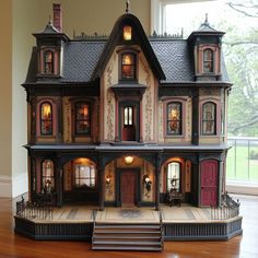 a large doll house sitting on top of a hard wood floor