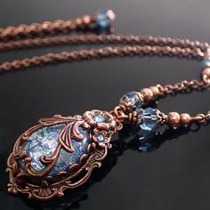 "To make this Victorian style necklace, I wrapped an aqua blue glass faux opal cabochon in exquisitely detailed antiqued copper filigree. The stone is set in an antique Victorian style setting and adorned with floral elements and coordinating crystals. --------------------------------------------------------------------------------------------- Dimensions and details - Focal cabochon measures 18x13mm - The drop of the entire pendant (top of setting to bottom of setting) is approximately 1 and 3/ Antique Wire Wrapped Jewelry As Gift, Bohemian Cabochon Jewelry For Formal Occasions, Unique Antique Finish Jewelry For Formal Occasions, Antique Finish Unique Jewelry For Formal Occasion, Elegant Antique Finish Jewelry Gift, Elegant Blue Decorative Jewelry, Formal Bohemian Jewelry With Cabochon, Elegant Bronze Copper Jewelry, Formal Bohemian Cabochon Jewelry