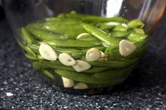 green beans and mushrooms are in a glass bowl on the counter, ready to be cooked