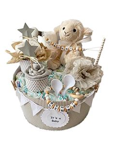 a teddy bear is sitting in a basket with other items on the top of it