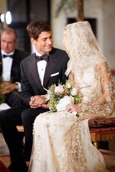 the bride and groom are sitting down together