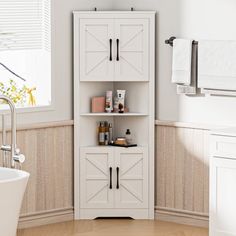 a bathroom with a sink, toilet and bathtub in the corner next to a window