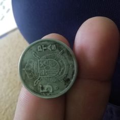 a person holding a coin in their hand