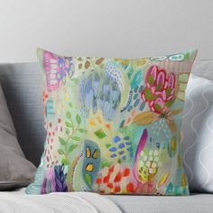 a colorful pillow sitting on top of a couch