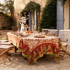 an outdoor table set for two with fall decorations