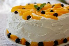 a cake with oranges and black olives on it