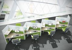 an office cubicle with multiple desks and chairs, all separated by dividers