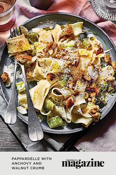 a plate of pasta with anchovy and walnut crumbs on the side