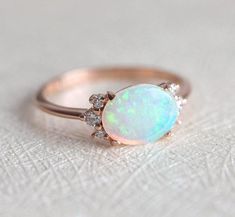 A gorgeous prong set Australian opal & diamond cluster engagement ring in 14k or 18k solid gold or platinum. The opal shines in a variety of special colors (blue, green, white, pink, ...). Lots of fire! This unique multi stone engagement, wedding or bridal cluster is available in 14k and 18k solid rose, white, yell Ethiopian Opal Oval Ring For Wedding, Oval Opal Cluster Ring For Wedding, Antique Opal Jewelry, White Gold Opal Ring, Oval Opal Ring, Gold Opal Ring, Rose Gold Opal Ring, Opal Diamond Ring, October Birthstone Rings