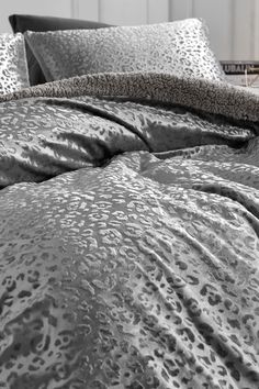 a black and white photo of a leopard print comforter